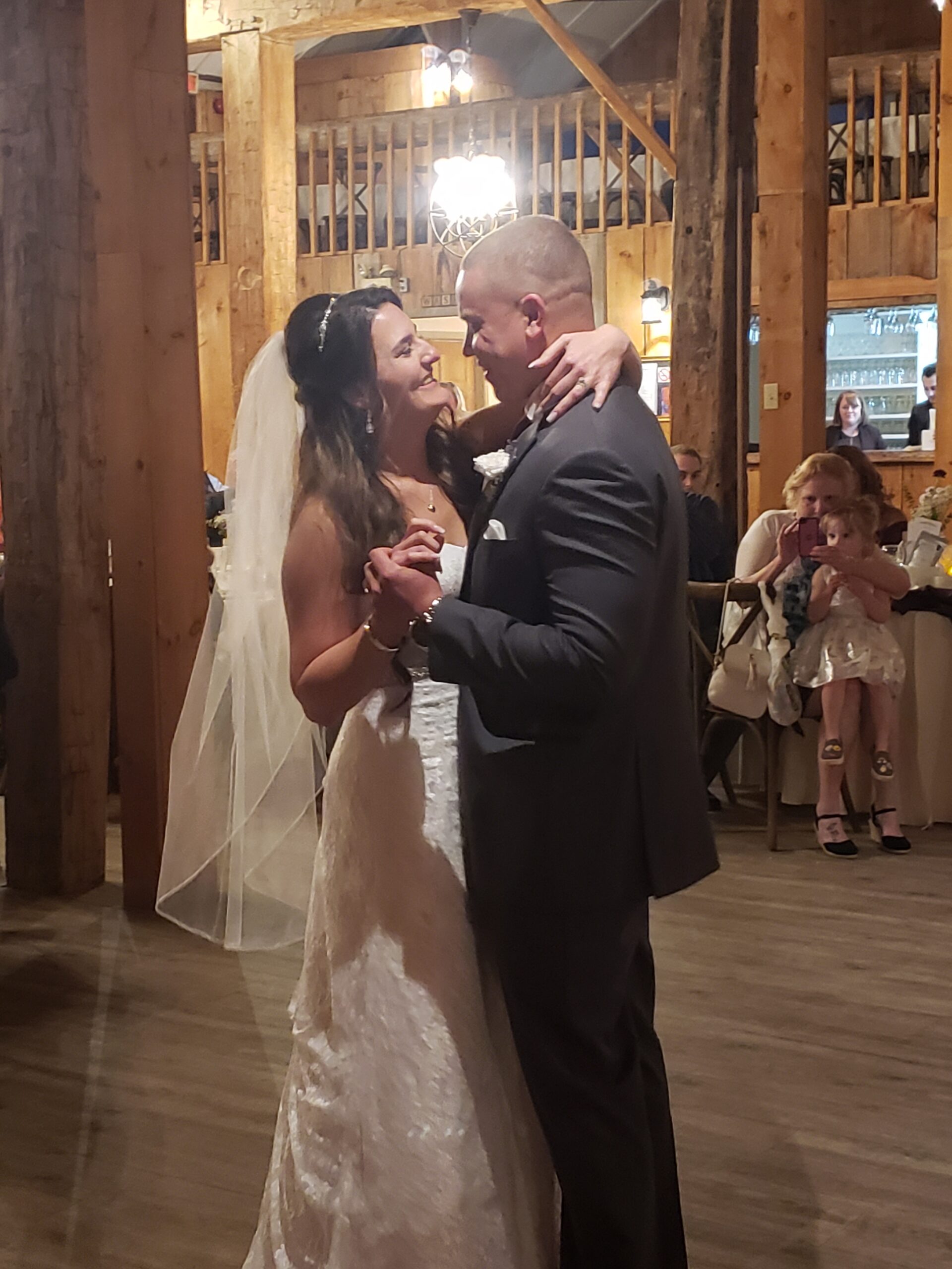 Bride and groom sharing a romantic dance at their wedding reception, with DJ entertainment provided by 2J's Music Machine.