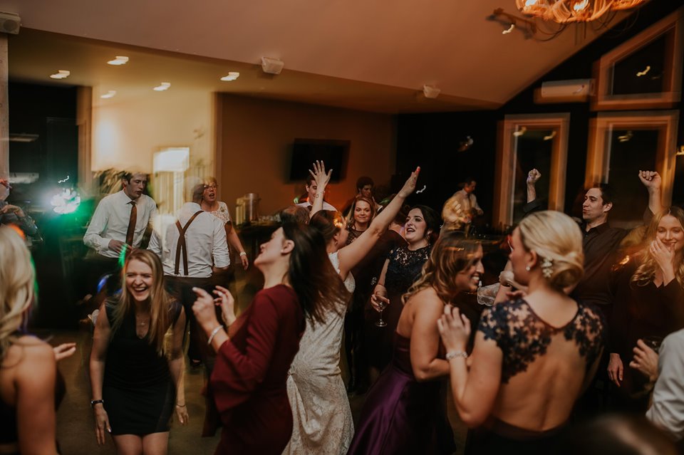 Wedding guests dancing and celebrating at an Ottawa wedding reception with DJ entertainment provided by 2J's Music Machine.